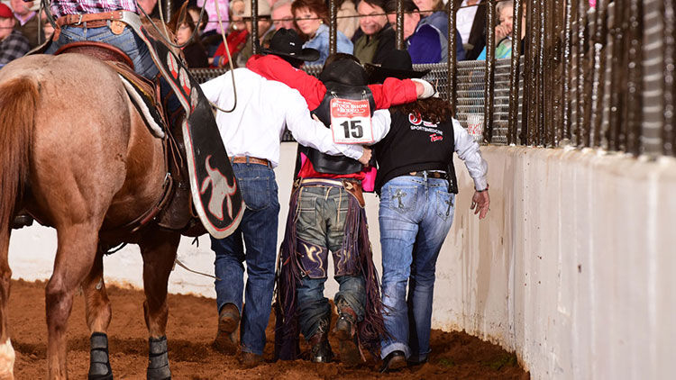 People help injured man out of arena.